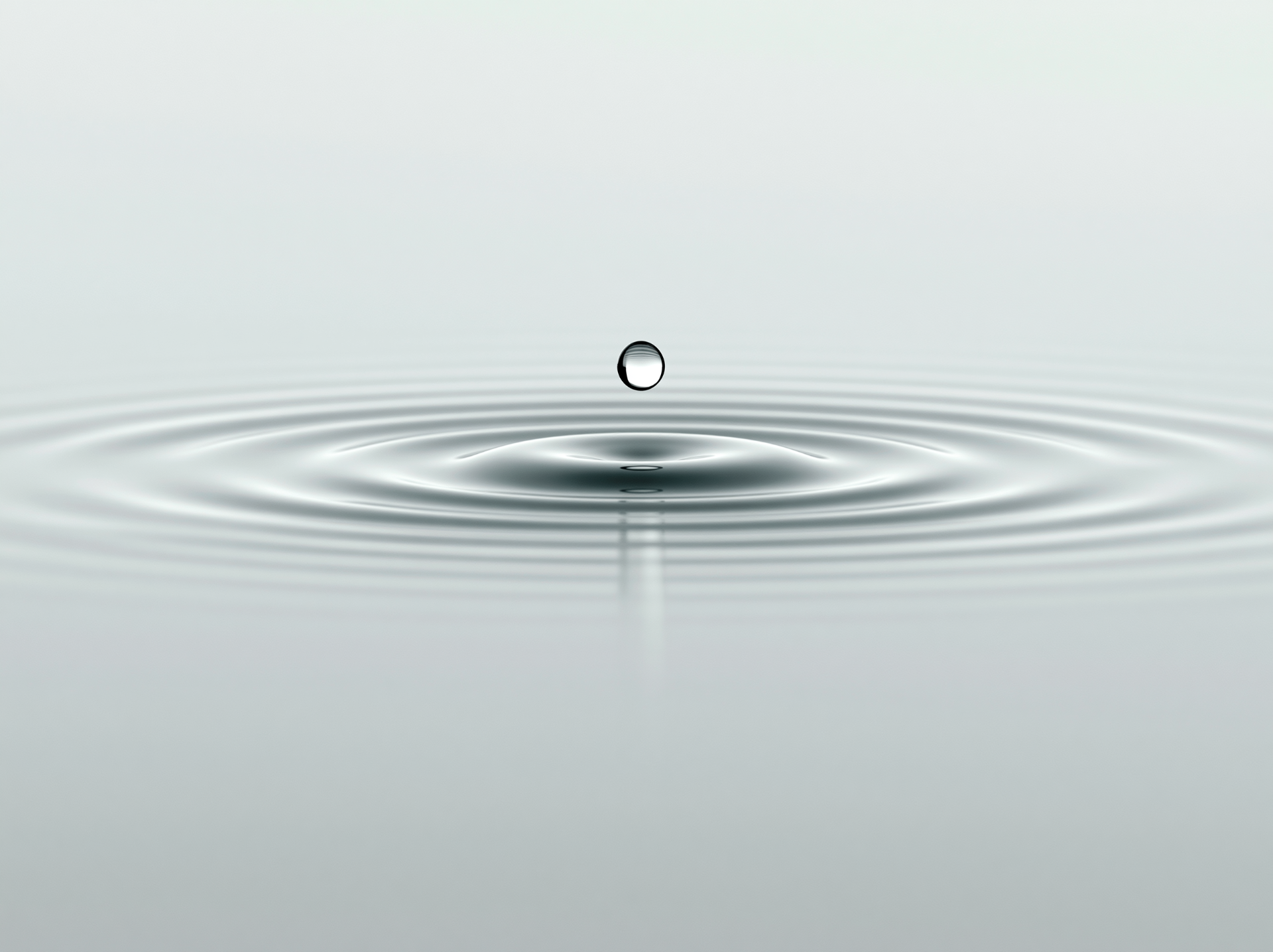 Water droplet rippling on a still surface